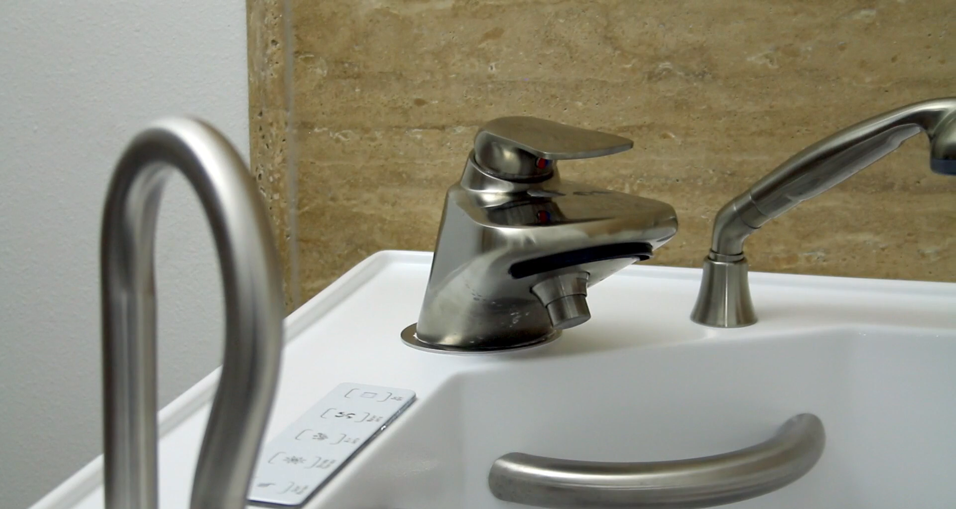 Close-up of walk-in tub grab bars and faucet hardware