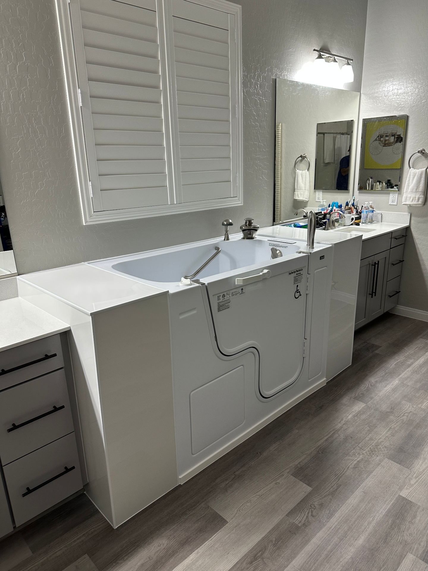 Walk-in bathtub installed in a modern Henderson bathroom with outswing door