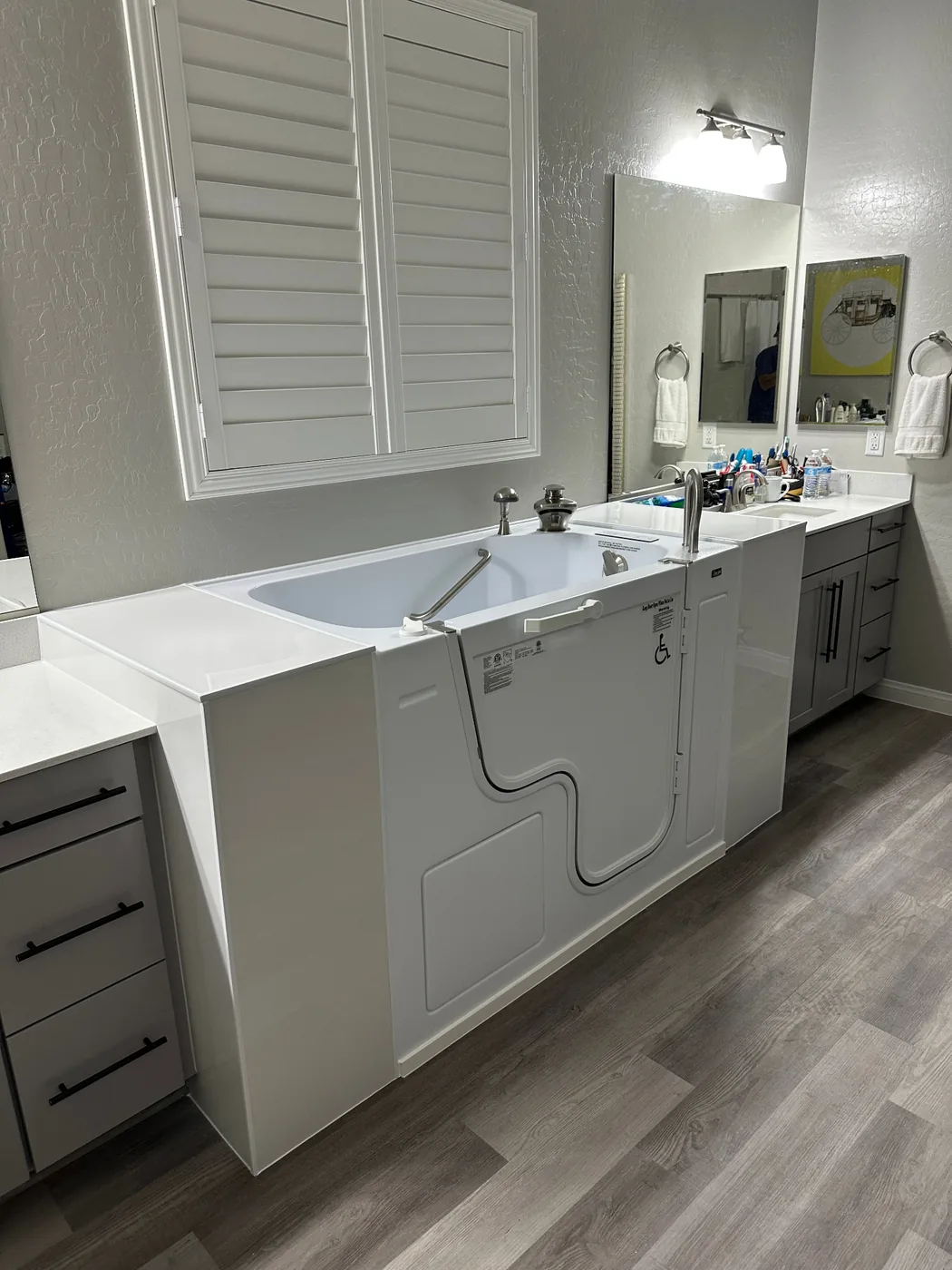 Walk-in bathtub installed in a modern Henderson bathroom with outswing door