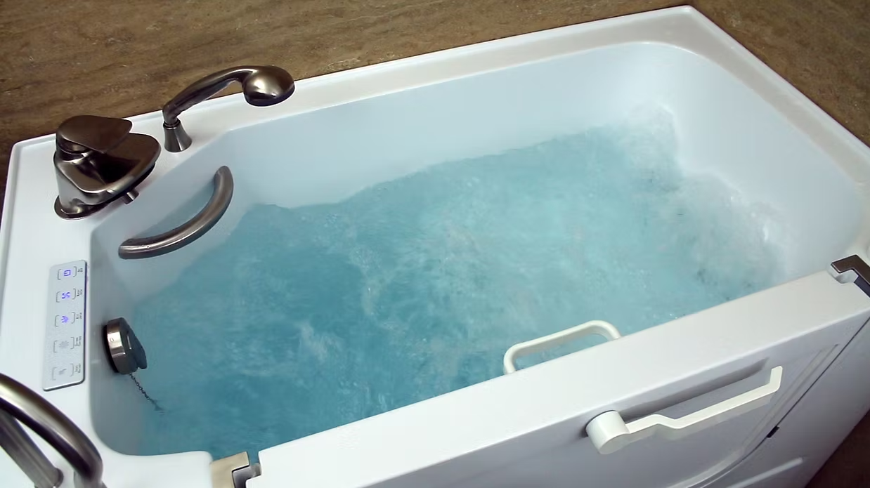 Hydrotherapy walk-in tub filled with water and whirlpool jets running